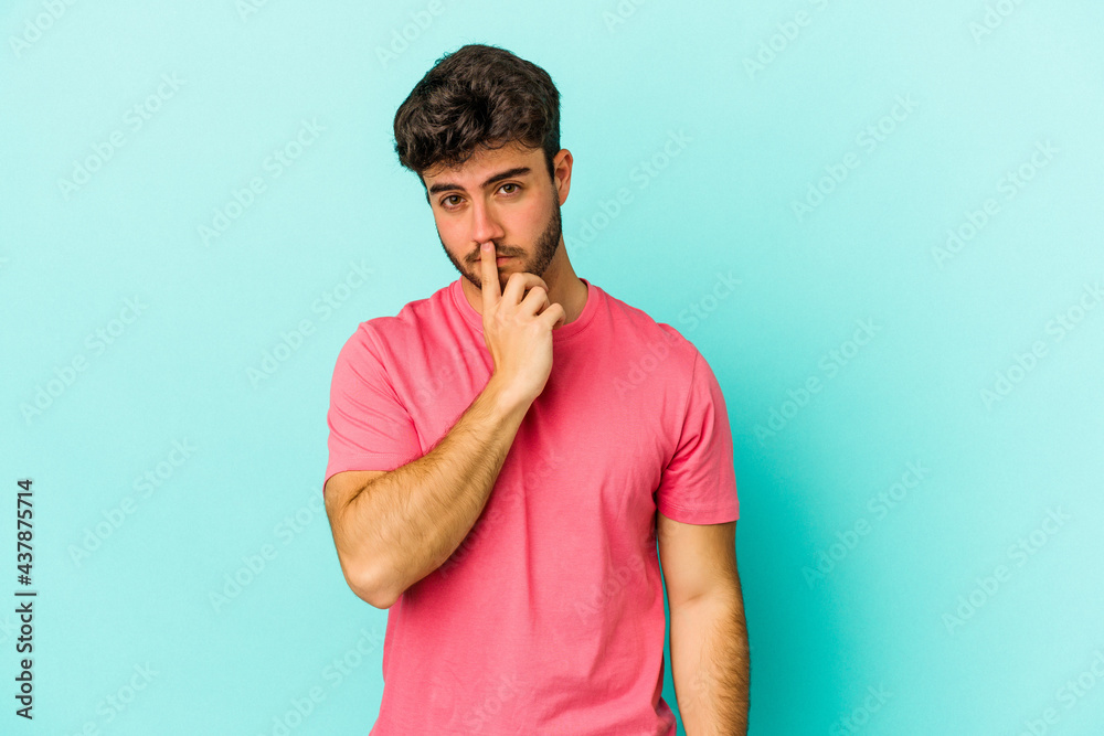 Young caucasian man isolated on blue background thinking and looking up, being reflective, contemplating, having a fantasy. Young caucasian man isolated on blue background thinking and looking up, being reflective, contemplating, having a fantasy.