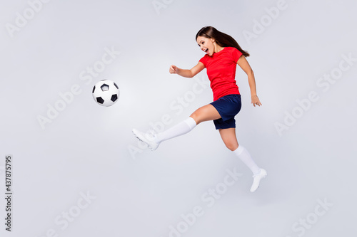 Full length profile photo of crazy air fly joy fun defender soccer team game kick ball jump run pass wear football uniform t-shirt shorts cleats long knee socks isolated white color background