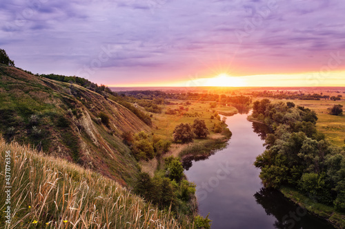 beautiful summer landscape sunrise over river with green meadow