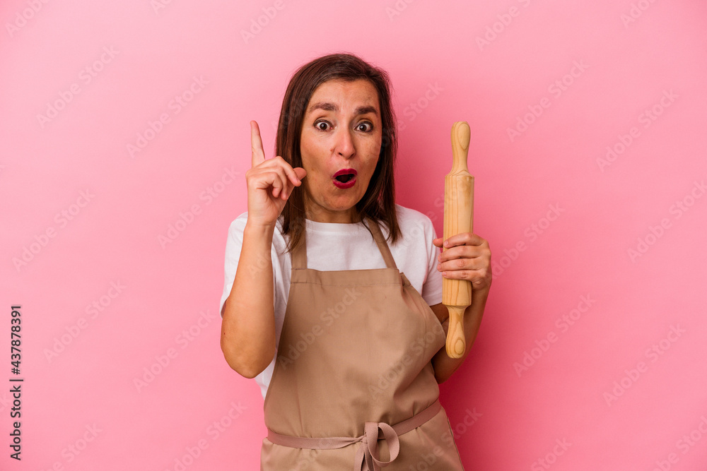 Middle age pastry chef woman isolated on pink background having an idea, inspiration concept. Middle age pastry chef woman isolated on pink background having an idea, inspiration concept.