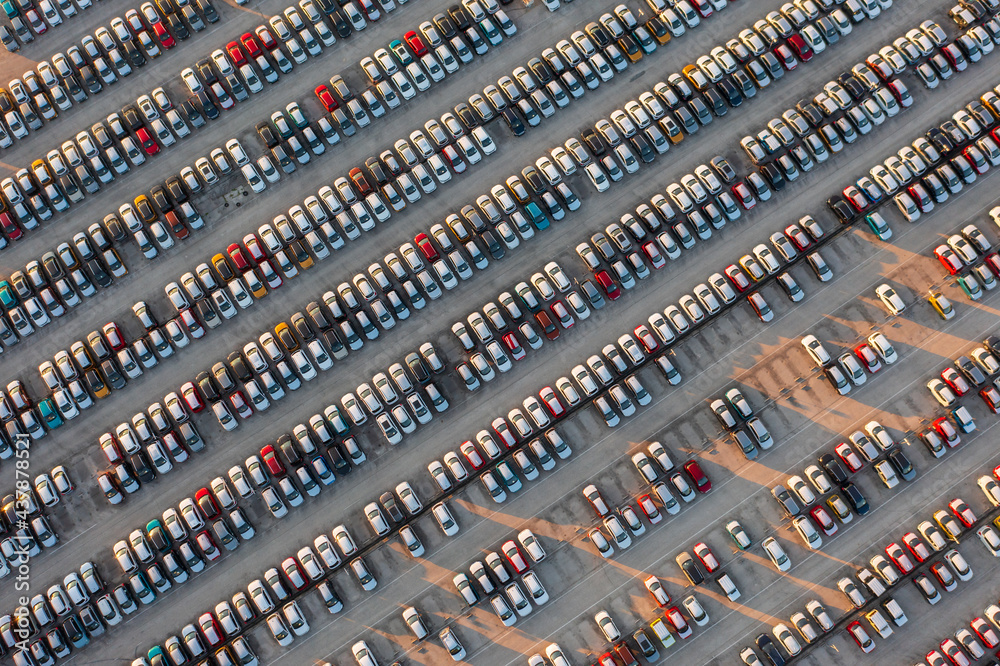 Obraz premium Aerial top down view of brand new cars at the logistics center, near the factory. Ready to export or import. Car parking lot.