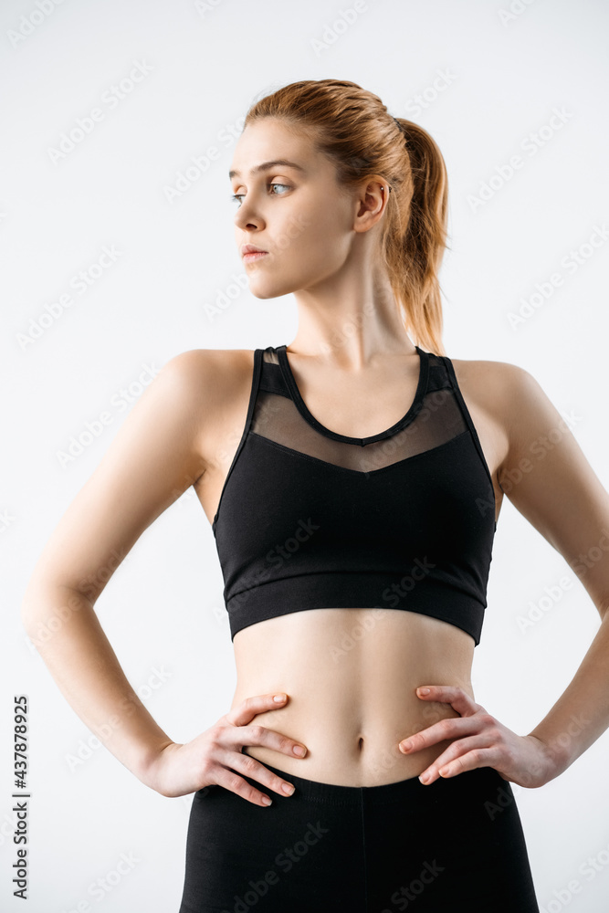 Woman sportswear. Clothing for branding. Active lifestyle. Fitness outfit. Front view of female athletic model with slim body in logo mockup black mesh crop top isolated on neutral. Woman sportswear. Clothing for branding. Active lifestyle. Fitness outfit. Front view of female athletic model with slim body in logo mockup black mesh crop top isolated on neutral.