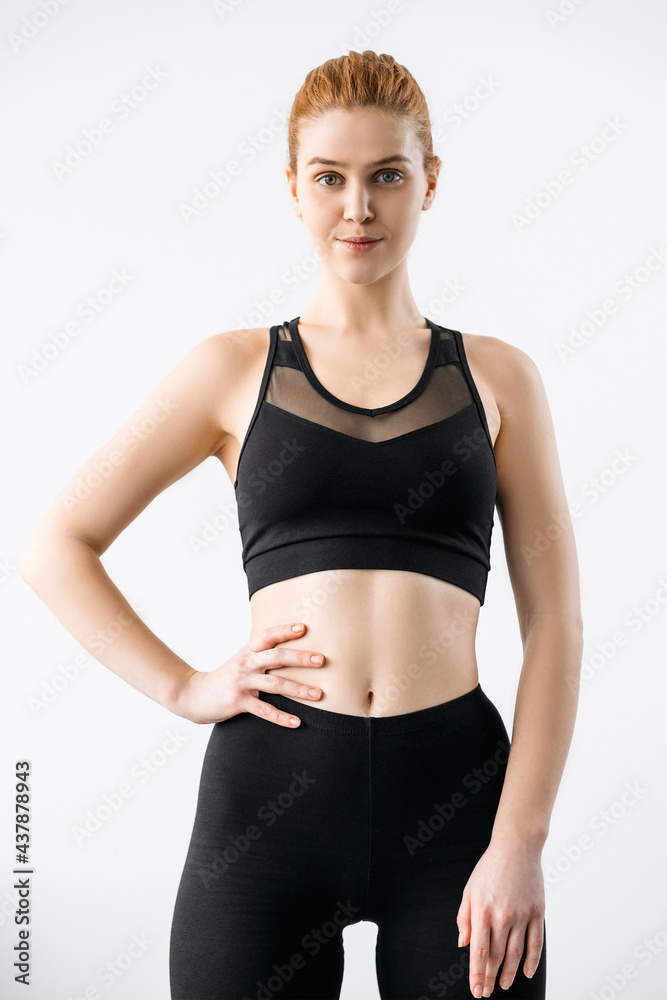 Fitness coach. Personal training. Yoga class. Confident female sport instructor with slim body in black sportswear crop top leggings isolated on light. Fitness coach. Personal training. Yoga class. Confident female sport instructor with slim body in black sportswear crop top leggings isolated on light.