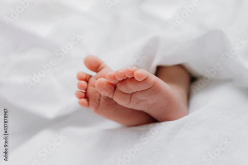 Baby's feet under a white blanket