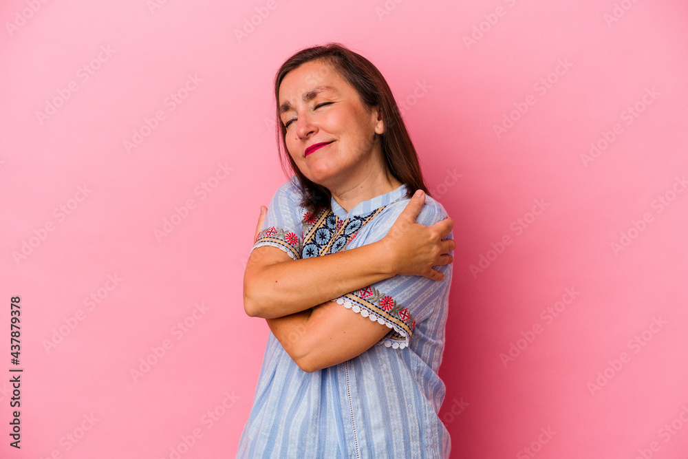 Middle age caucasian woman isolated on pink background hugs, smiling carefree and happy. Middle age caucasian woman isolated on pink background hugs, smiling carefree and happy.