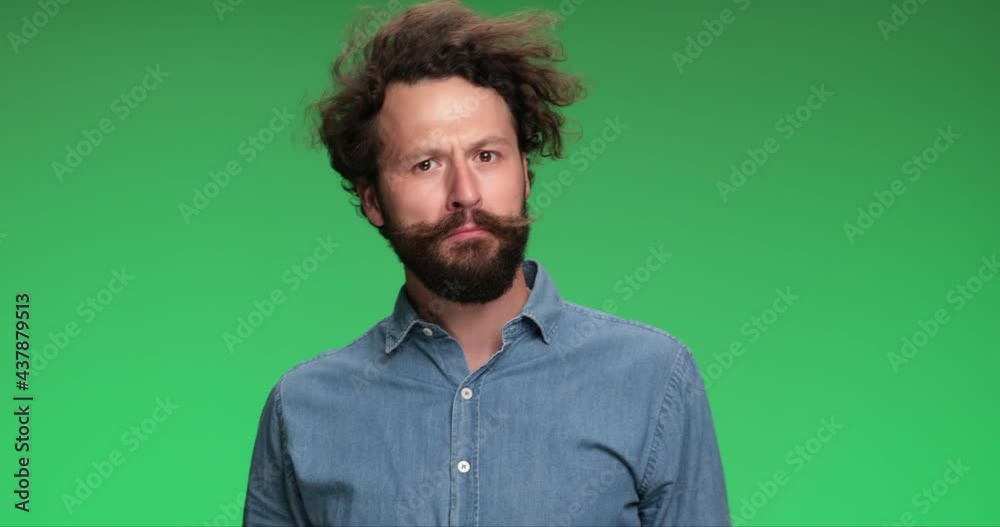 young casual man walking on his way, being distracted, touching his beard, thinking then figuring out and giving an ok sign young casual man walking on his way, being distracted, touching his beard, thinking then figuring out and giving an ok sign