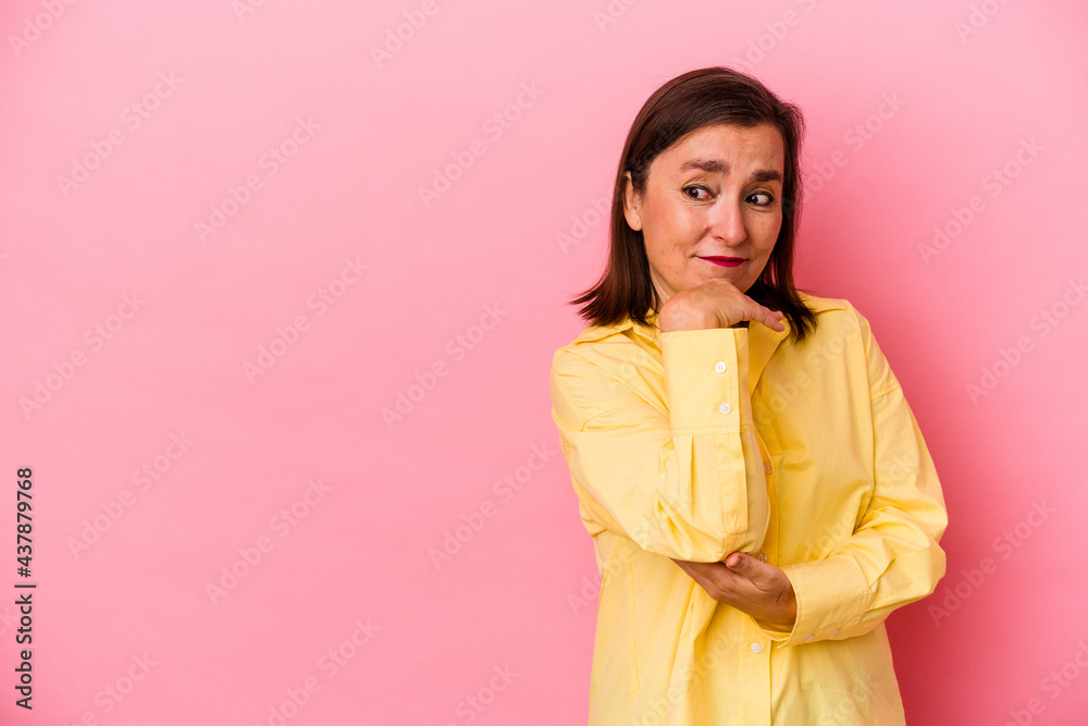 Middle age caucasian woman isolated on pink background looking sideways with doubtful and skeptical expression. Middle age caucasian woman isolated on pink background looking sideways with doubtful and skeptical expression.