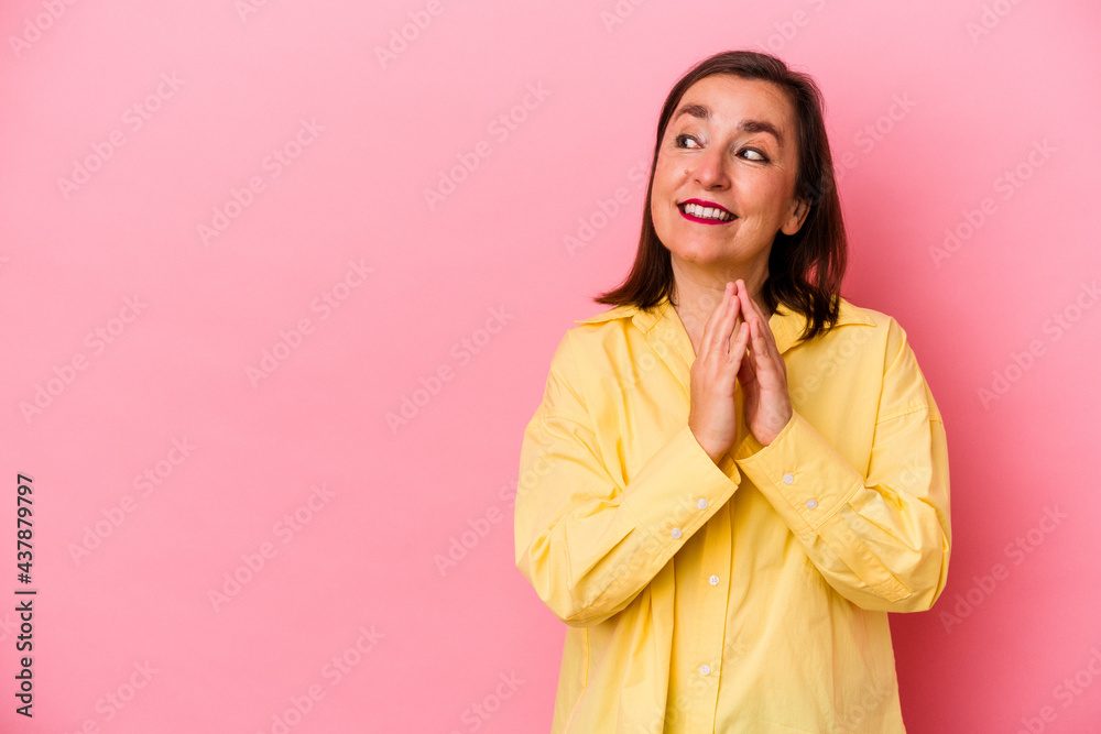 Middle age caucasian woman isolated on pink background making up plan in mind, setting up an idea.