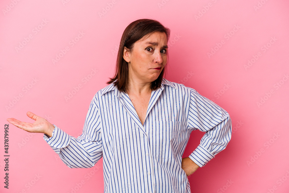 Middle age caucasian woman isolated on pink background doubting and shrugging shoulders in questioning gesture. Middle age caucasian woman isolated on pink background doubting and shrugging shoulders in questioning gesture.