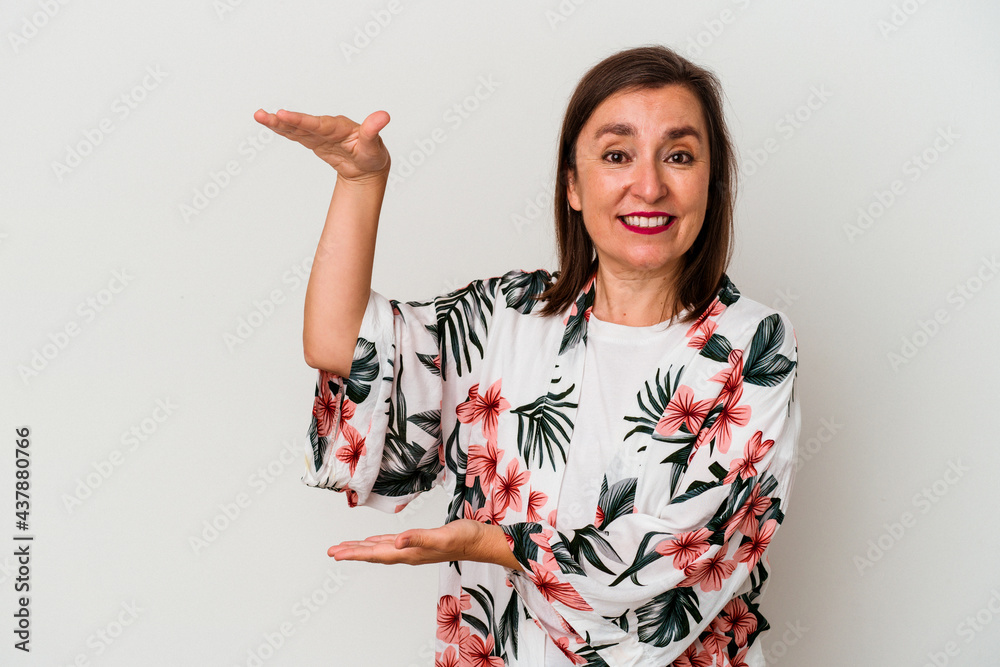 Middle age caucasian woman isolated on white background shocked and amazed holding a copy space between hands. Middle age caucasian woman isolated on white background shocked and amazed holding a copy space between hands.