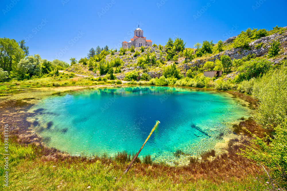 Cetina river source water hole and Orthodox church on the hill view