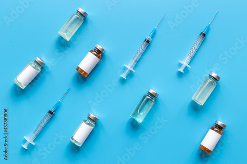 Vaccination with Covid vaccine in bottles with syringe