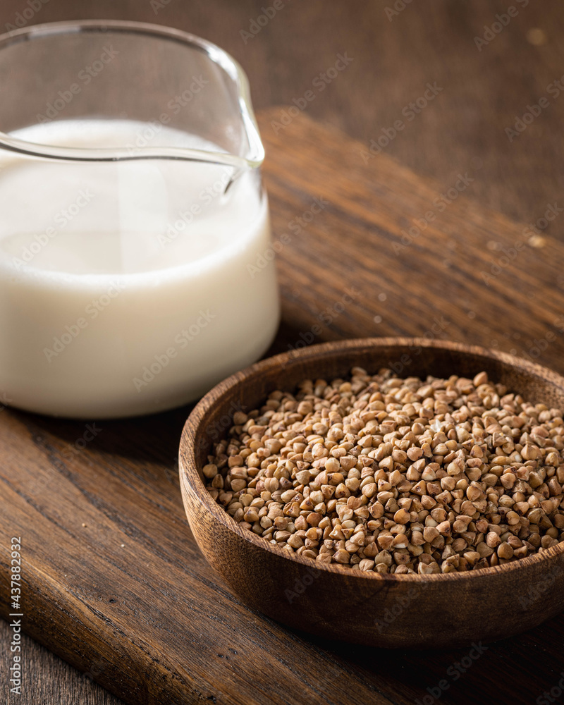 buckwheat and buckwheat milk on a wooden kitchen board, gluten-free. buckwheat and buckwheat milk on a wooden kitchen board, gluten-free.