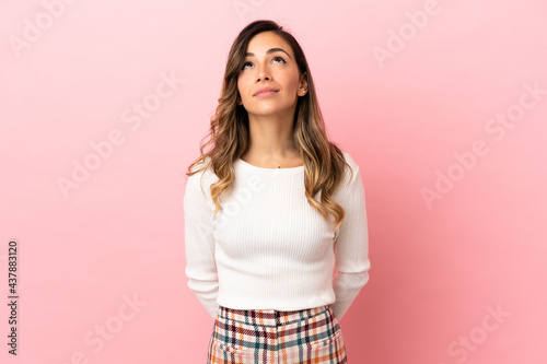Young woman over isolated background and looking up