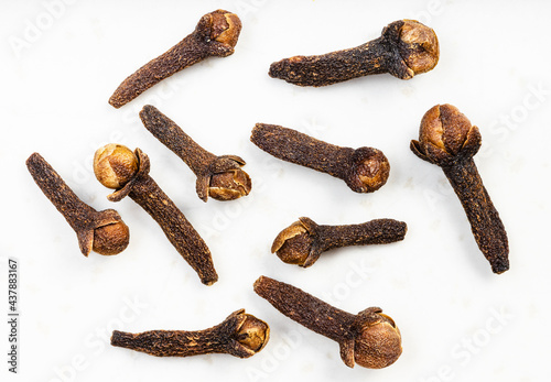 several whole dried cloves close up on gray photo