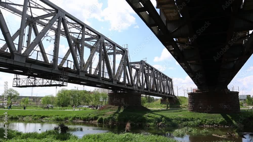 Railway bridge over the river, bottom view in the summer Railway bridge over the river, bottom view in the summer