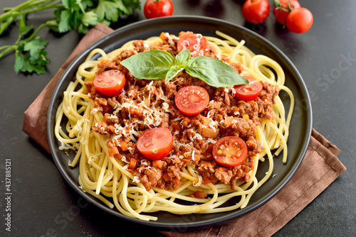 Tasty spaghetti with minced meat  cherry tomatoes and parmesan cheese on plate