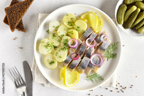 Sliced herring fish with boiled potatoes