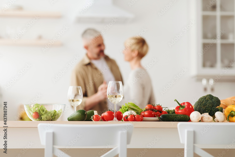Happy loving couple, romantic dance on date in modern kitchen, smiling husband and wife celebrate anniversary Happy loving couple, romantic dance on date in modern kitchen, smiling husband and wife celebrate anniversary