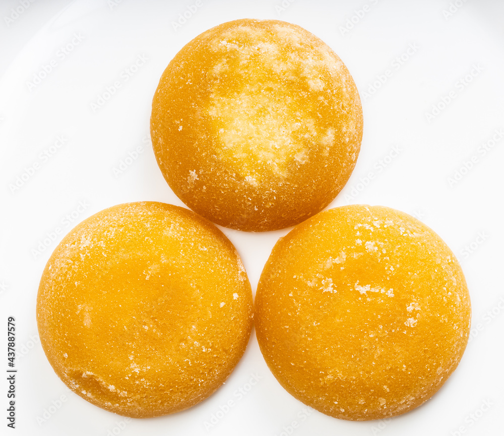 few whole round pieces of palm sugar on gray few whole round pieces of palm sugar on gray