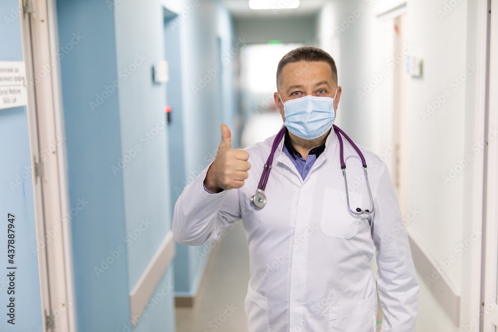 Portrait of a friendly doctor smiling giving thumbs up Portrait of a friendly doctor smiling giving thumbs up