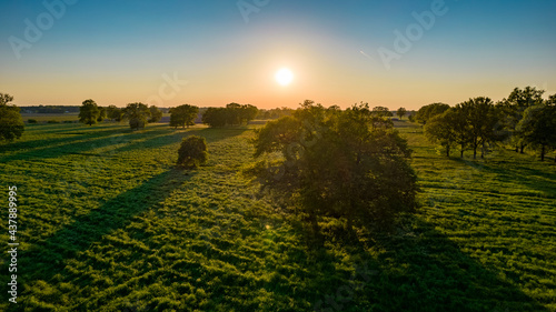 Aerial photo of agricultural fields with beautiful sunset with sun rays taken with a drone. High quality photo