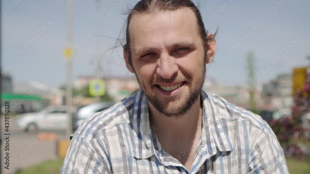 Portrait of happy smiling long haired man with a small beard looking in camera. Portrait of happy smiling long haired man with a small beard looking in camera.