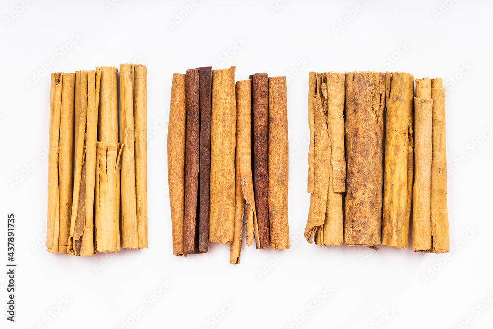 top view of various cinnamon sticks on white plate top view of various cinnamon sticks on white plate