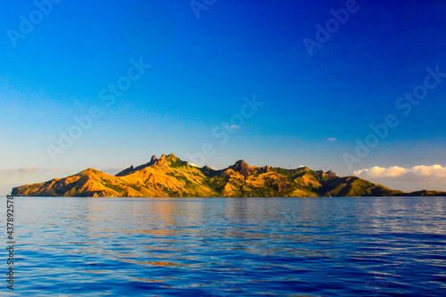 Very dramatic peaks of the northern end of Waya Island with a warm afternoon glow in Fiji's Yasawa Islands located in the South Pacific