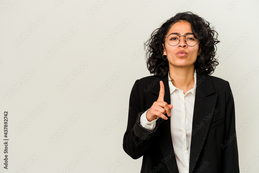 Young latin business woman isolated on white background showing number one with finger. Young latin business woman isolated on white background showing number one with finger.