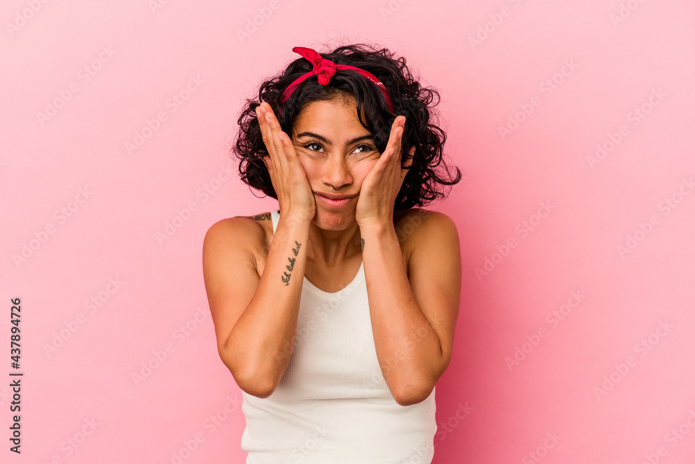 Young curly latin woman isolated on pink background whining and crying disconsolately.