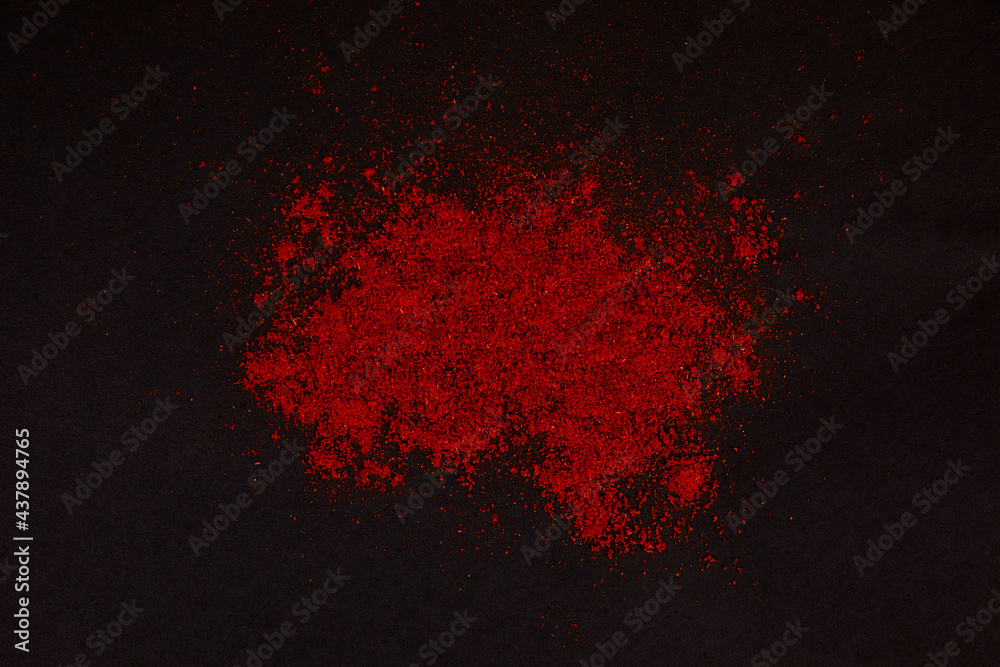 Powder of paprika splash in black background. Powder of paprika splash in black background.