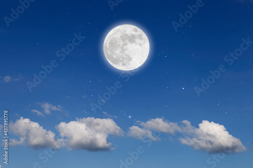 Romantic night with full moon in space over stars with cloudscape background.