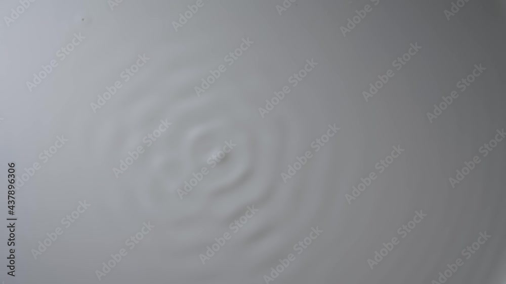 Wave motion of white surface milky liquid when excited by vibration. Changes in nature of waves and ripple on surface of milk with change in frequency of exciting vibration. Slow motion. Close up. Wave motion of white surface milky liquid when excited by vibration. Changes in nature of waves and ripple on surface of milk with change in frequency of exciting vibration. Slow motion. Close up.