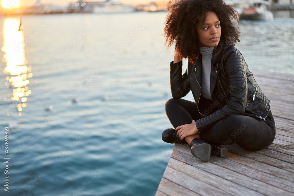 Beautiful black woman resting on pier