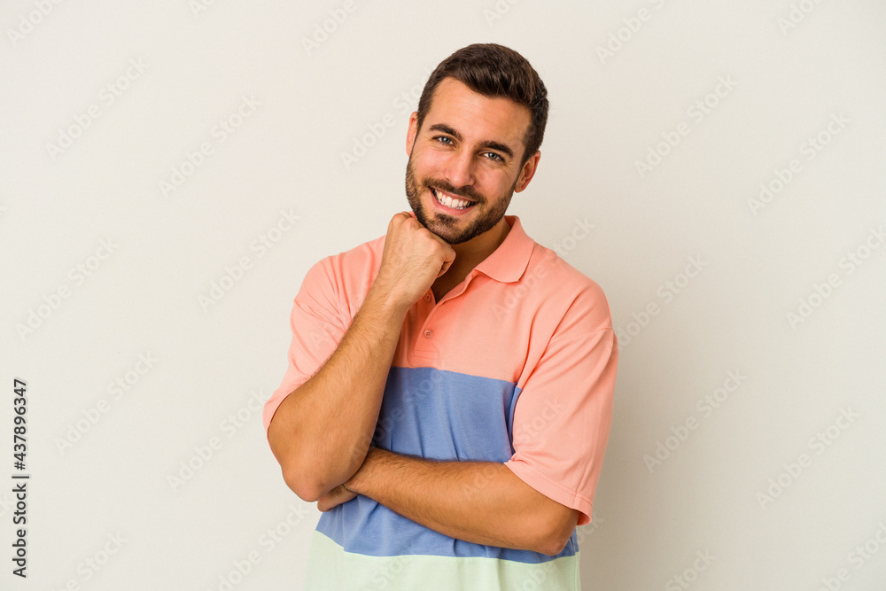 Young caucasian man isolated on white background smiling happy and confident, touching chin with hand. Young caucasian man isolated on white background smiling happy and confident, touching chin with hand.