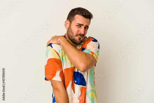 Young caucasian man isolated on white background having a shoulder pain.