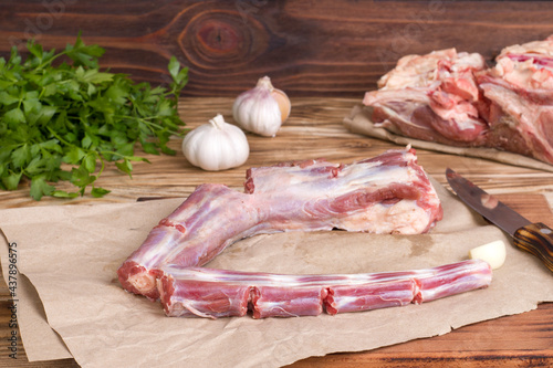 Whole fresh raw beef tail sliced into pieces on wooden background photo