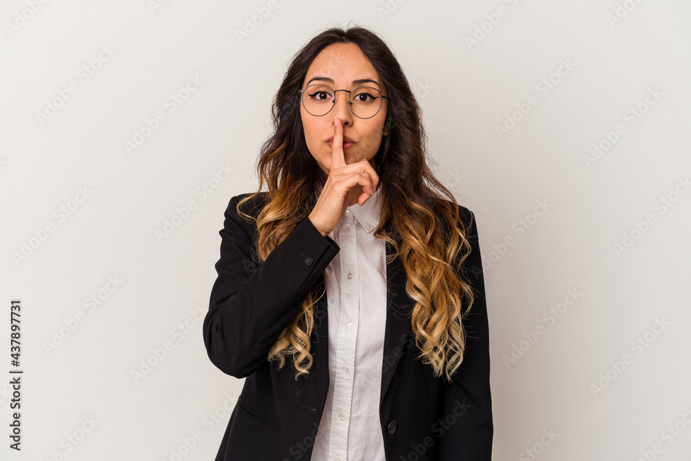 Young mexican business woman isolated on white background keeping a secret or asking for silence. Young mexican business woman isolated on white background keeping a secret or asking for silence.