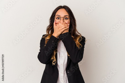 Young mexican business woman isolated on white background shocked covering mouth with hands.