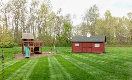 Tablou pe pânză Shed and Playset on Mown Lawn