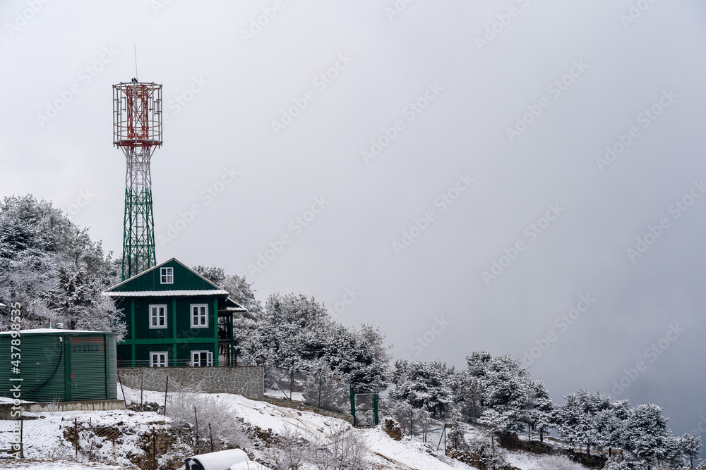 Snow Covered Hillside and Radio Tower