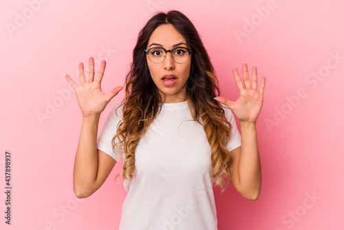 Young mexican woman isolated on pink background screaming to the sky, looking up, frustrated.