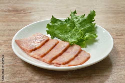 fried pork bacon slice arranging with lettuce on plate