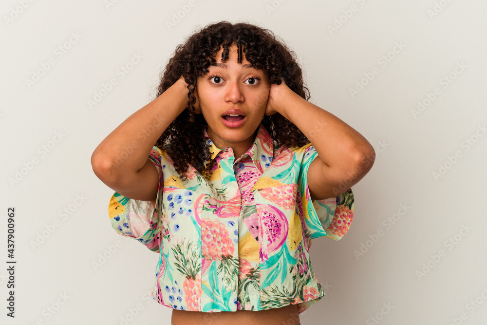 Young mixed race woman isolated on white background covering ears with hands trying not to hear too loud sound. Young mixed race woman isolated on white background covering ears with hands trying not to hear too loud sound.