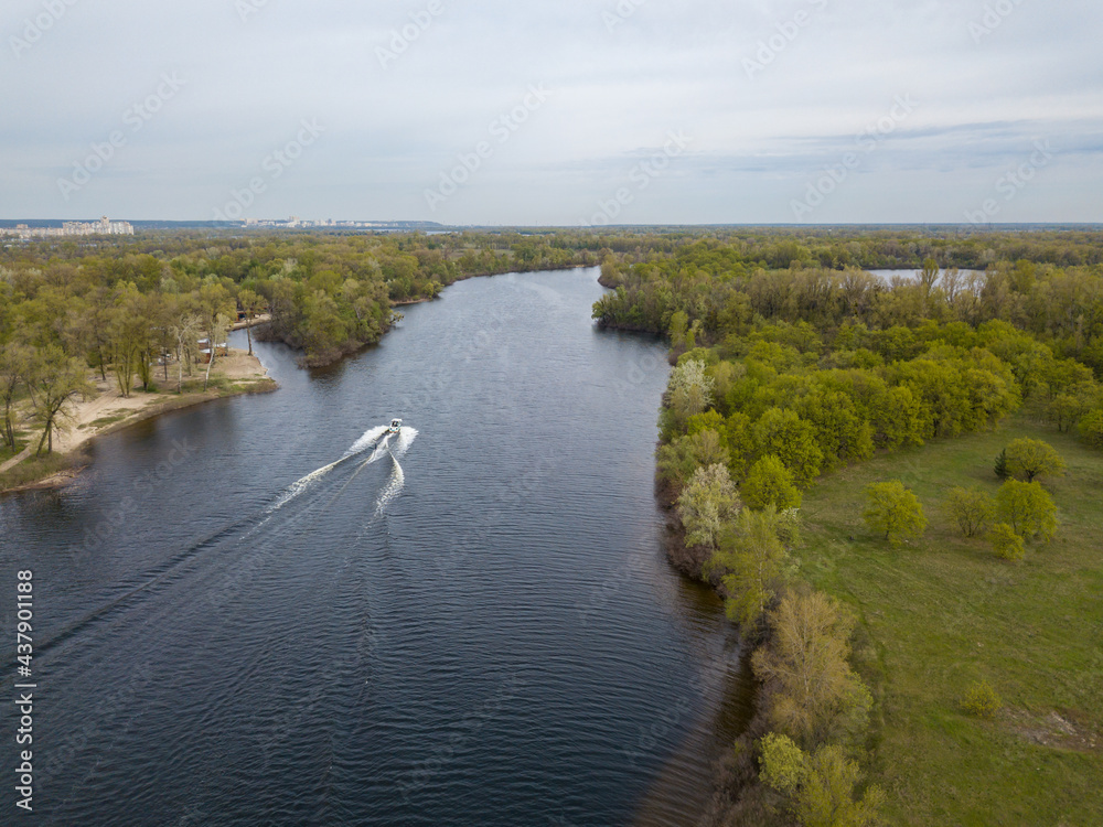 Motor boat with water skis on the river. Aerial drone view.