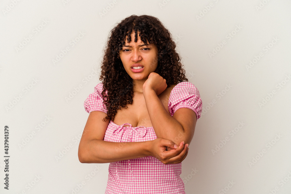 Young mixed race woman isolated on white background massaging elbow, suffering after a bad movement. Young mixed race woman isolated on white background massaging elbow, suffering after a bad movement.