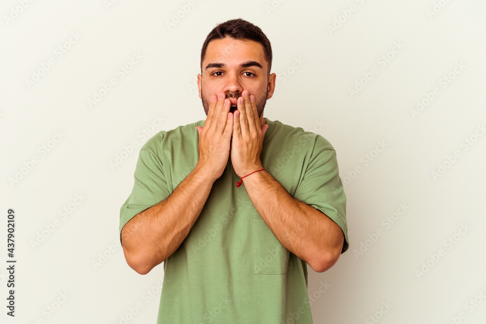 Young caucasian man isolated on white background shocked, covering mouth with hands, anxious to discover something new. Young caucasian man isolated on white background shocked, covering mouth with hands, anxious to discover something new.