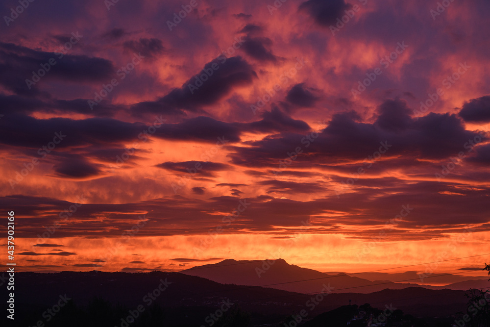 Beautiful red sunset with clouds overlooking the Montseny mountain in Spain.