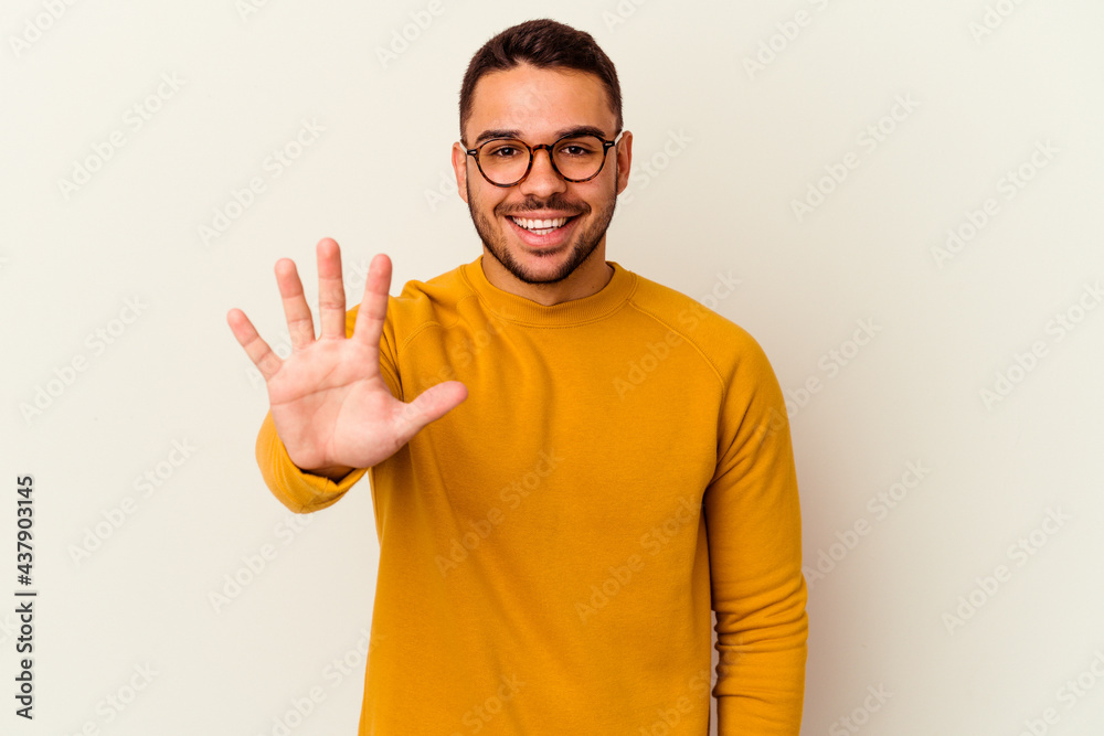 Young caucasian man isolated on white background smiling cheerful showing number five with fingers. Young caucasian man isolated on white background smiling cheerful showing number five with fingers.